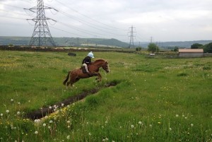 PRACTISING: A young Pony Club member enjoying cross country PRACTISING: A young Pony Club member enjoying cross country