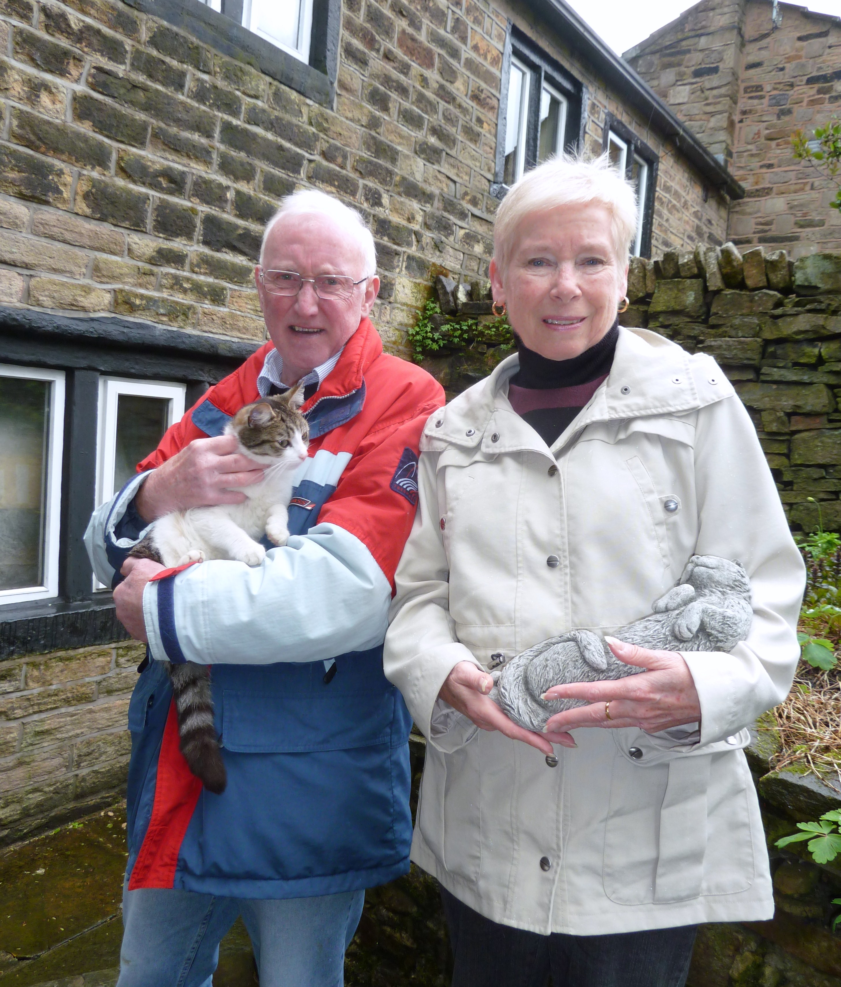 THANKFUL: Lin and David with one of their pets and an effigy from their garden THANKFUL: Lin and David with one of their pets and an effigy from their garden