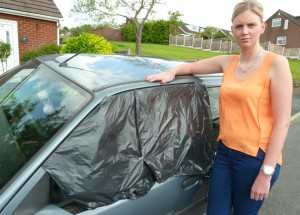 ORDEAL: Rachel beside her damaged car