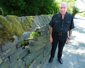 FRUSTRATED: Pat Kelly at his damaged garden wall FRUSTRATED: Pat Kelly at his damaged garden wall