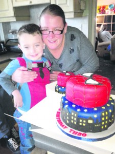 Picture: Theo Carnie and his mum Verity with the cake and fake cake made by Kerri 