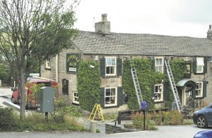 GONE: Workmen prune the Ivy outside the pub
